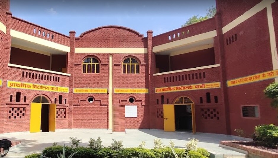 Pali_a red brick building with a clock on the front of it